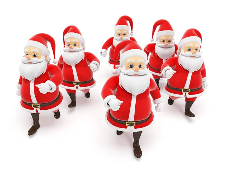 A group of seven cheerful, cartoonish Santa Clauses, each wearing a classic red and white Santa suit with black boots and belts, is walking forward with smiles on their faces. The background is plain white.