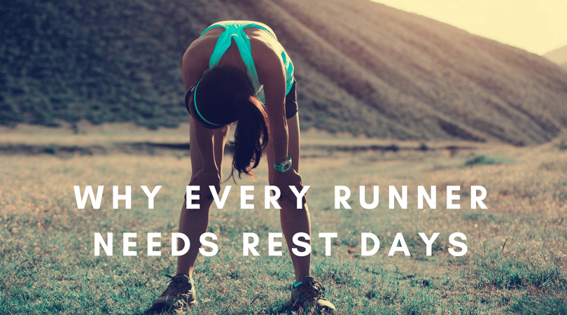 A tired runner with hands on knees, wearing athletic gear, takes a rest in a hilly landscape. The text overlay reads, "WHY EVERY RUNNER NEEDS REST DAYS".