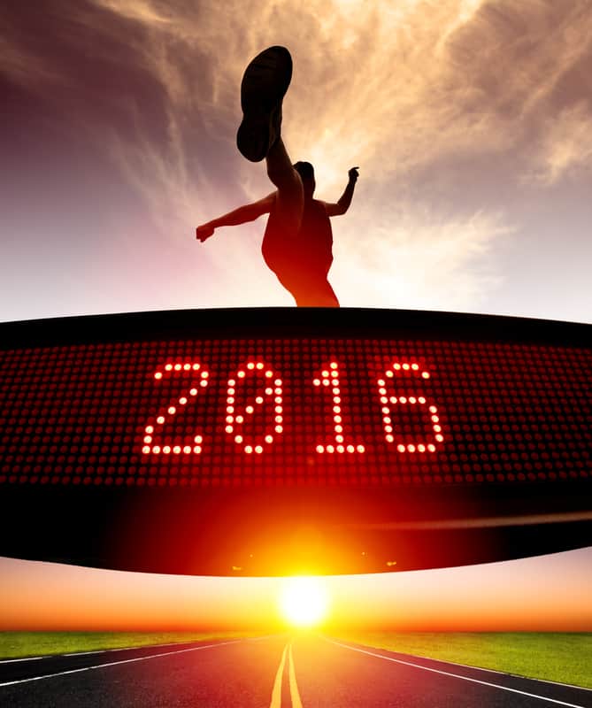 A person is leaping joyfully against a backdrop of a vibrant sunset and an open road. An electronic display in the foreground shows the year "2016" in bright red LED numbers, symbolizing the start of a new journey.