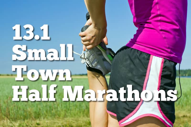 A person in athletic clothing is stretching their leg while holding a sneaker against a green field background. The text on the image reads "13.1 Small Town Half Marathons.