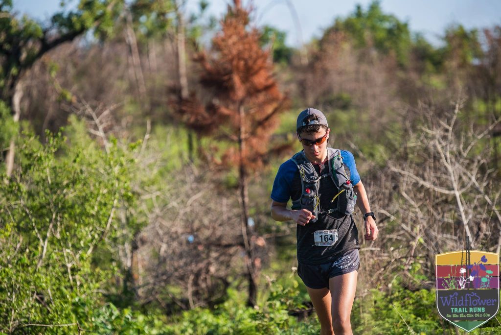 A runner in the trail course of Wildflower Trail Run