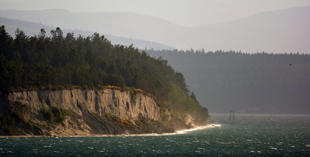 Puget Sound as all the waters south of three entrances from the Strait of Juan de Fuca.