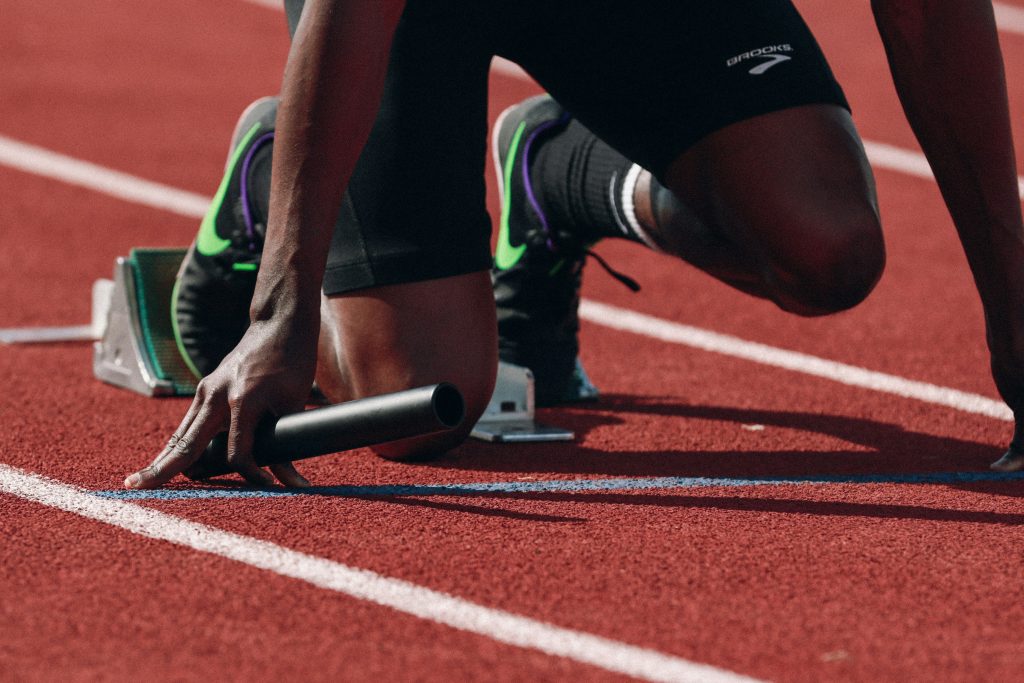 Runner setting his feet on a track to run fast.