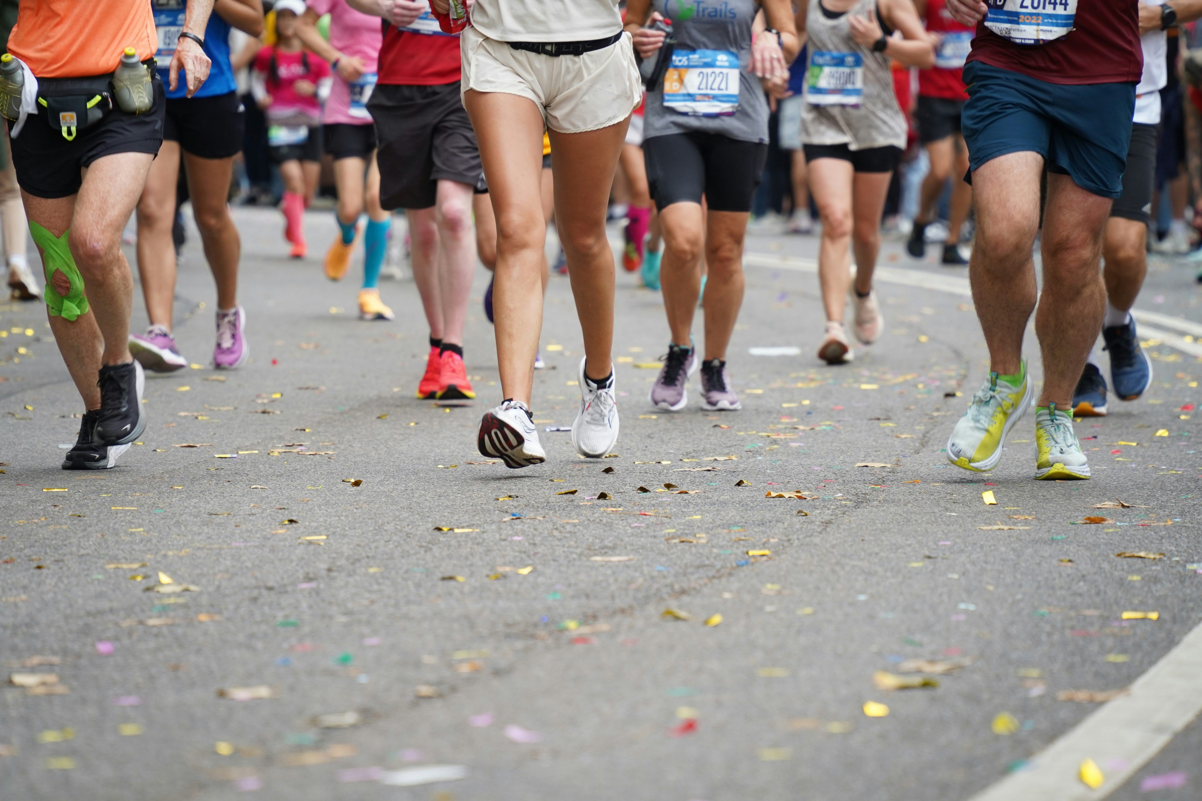 The legs of runners participating in a marathon after training.