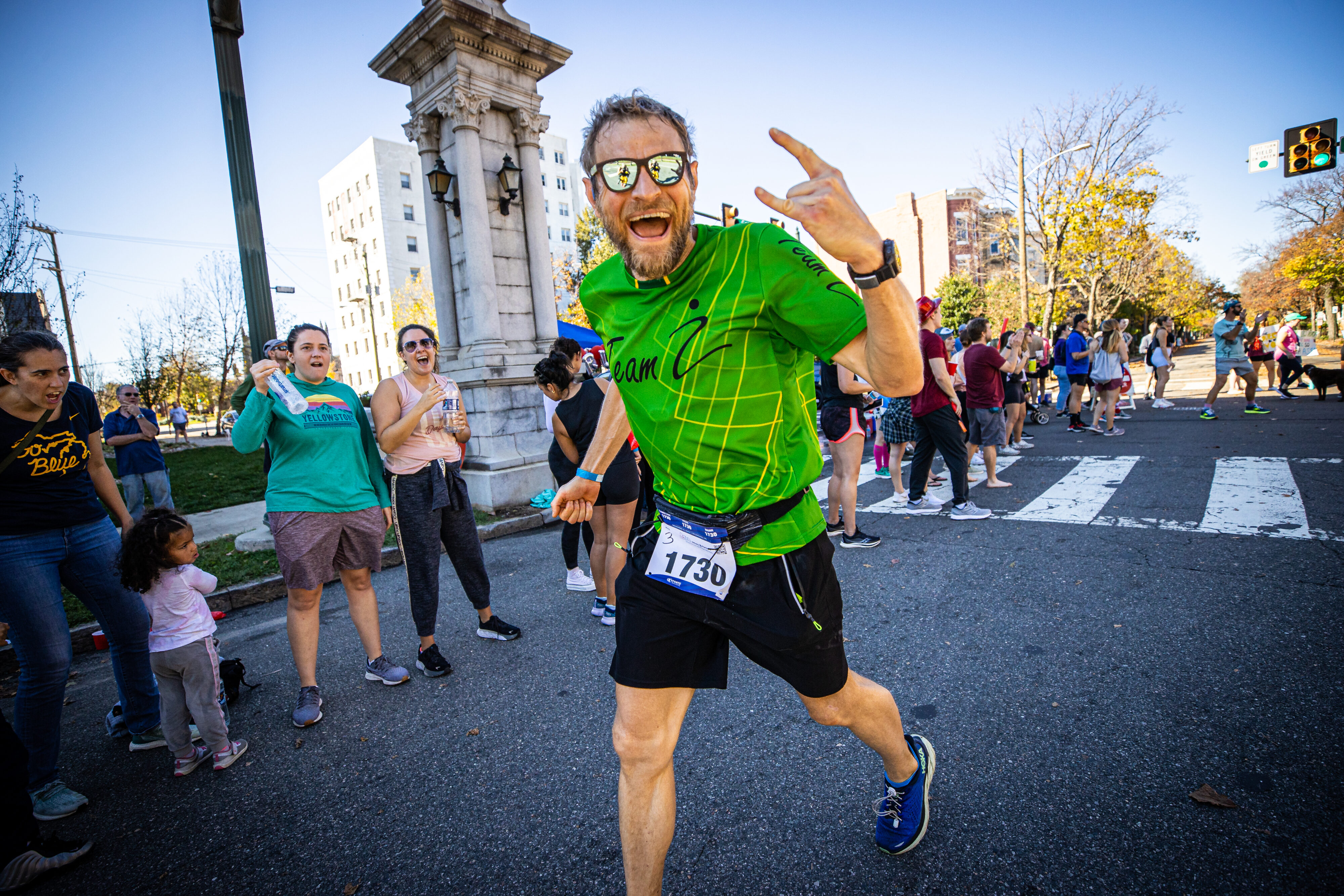 Man running the Richmond Marathon having fun and smiling at the camera